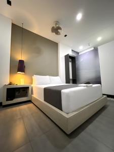 Postel nebo postele na pokoji v ubytování Hotel 47 Medellin Center