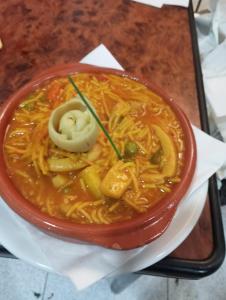 a bowl of soup sitting on a table at Pensión Xiquena in Fiñana