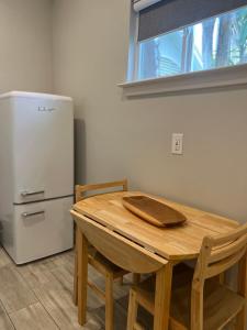 a kitchen with a wooden table and a refrigerator at Private modern guesthouse, near La Cantera/Medical Center in San Antonio