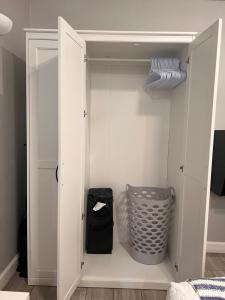 a closet with a door open with a basket at Private modern guesthouse, near La Cantera/Medical Center in San Antonio