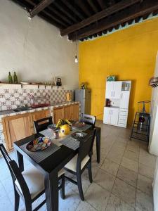 a kitchen with a table and chairs and a kitchen with a refrigerator at Casa colonial céntrica Guanajuato in Guanajuato