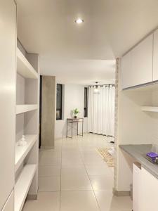 a kitchen with white cabinets and a tile floor at Windhoek perfect stay in Windhoek