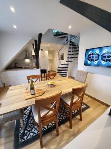 a kitchen and dining room with a wooden table and chairs at Golden Apartments in Essen