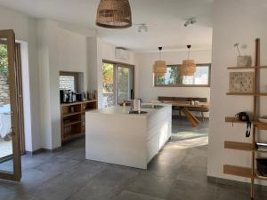 a kitchen with a white island in a room at Villa Marumare in Milna