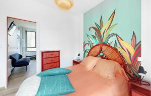 Schlafzimmer mit einem Bett mit Wandgemälde in der Unterkunft 1 Bedroom Cozy Apartment In Melrand in Melrand