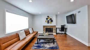 a living room with a couch and a fireplace at H&H Modern Lux 4BD 1 King Suite 3 Queen SoCal Disney in Westminster