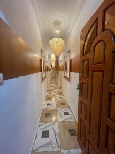 a hallway with a tile floor and a door at Heaven Surf Camp in Agadir