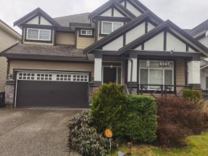 a house with a black garage at Luxurious house in willoughby center in Langley