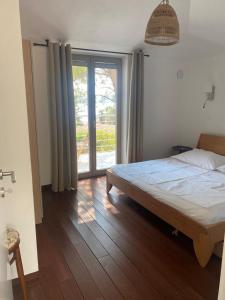a bedroom with a bed and a large window at Villa Marumare in Milna