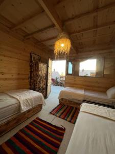 a bedroom with two beds in a log cabin at Heaven Surf Camp in Agadir