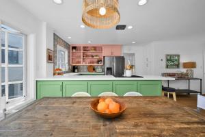 eine Küche mit einem Holztisch mit einer Schüssel Orangen in der Unterkunft Chic Modern Designed Home with Private Studio in Newport Beach