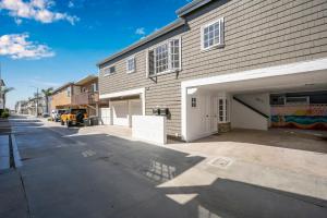 an empty parking lot next to a building with a garage at Chic Modern Designed Home with Private Studio in Newport Beach