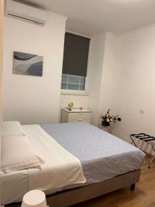 a white bedroom with a bed and a window at Step by Rome apt in Rome