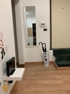 a living room with a mirror and a white table at Step by Rome apt in Rome