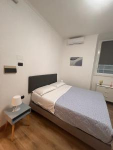 a bedroom with a large bed and a window at Step by Rome apt in Rome