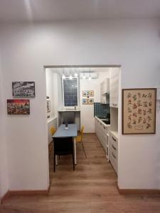 a kitchen and dining room with a table and chairs at Step by Rome apt in Rome