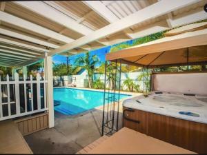 a hot tub in a room next to a swimming pool at Palm Villa Disneyland Pool 4 Bedroom 3 Bath HotTub in Anaheim