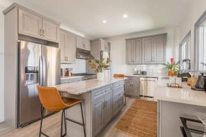 a kitchen with white cabinets and stainless steel appliances at Manhattan Beach Family Suite Stylish 2 BR 1BA Parking in Manhattan Beach