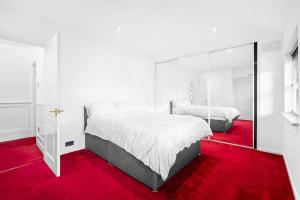 a bedroom with two beds and a red carpet at JLR,NEC,Resort World,Bham Airport,HS2 Contractor in Birmingham
