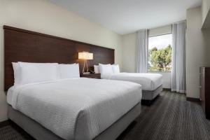 a hotel room with two beds and a window at Staybridge Suites Carlsbad/San Diego, an IHG Hotel in Carlsbad