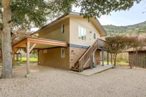 a large house with a porch and a staircase at Scenic Carmel Valley Home with Deck Steps to River! in Carmel Valley