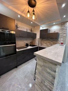 a large kitchen with a large island in the middle at T3 5 étoile jacuzzi in Toulouse +14 photos