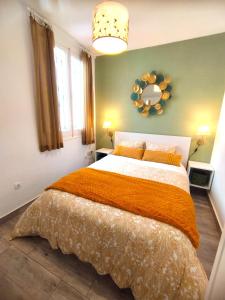 a bedroom with a large bed with an orange blanket at Madrid Centro in Madrid