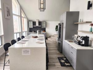 a kitchen with a large white island in a room at Large 3200sf A-Frame House close to Snowbird Alta Ski &Stunning Mountain View! in Sandy