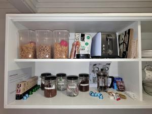 a kitchen pantry with jars and other food items at No.8 - One bedroom retreat in central Bendigo in Bendigo