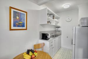 a kitchen with a table with a bowl of fruit on it at No.8 - One bedroom retreat in central Bendigo in Bendigo