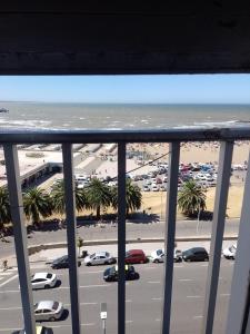 a view of a parking lot and the ocean from a balcony at Frente al mar in Mar del Plata