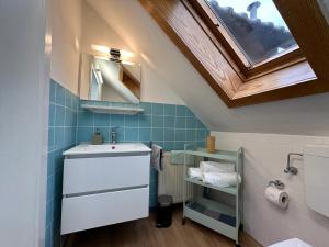 a bathroom with a sink and a window at Cleo Apartments in Kassel