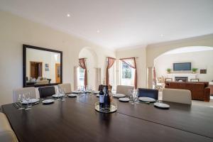 a large dining room with a large table with wine glasses at Casa Ferrel in Lagos