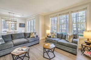 a living room with two couches and a table at Chic Greensboro Condo with Lake Oconee Access! in Greensboro