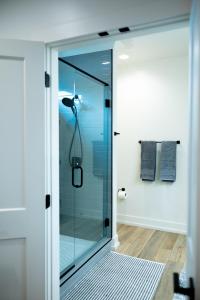 a shower with a glass door in a bathroom at New Modern Style Townhome in Sevierville