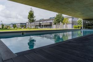 an empty swimming pool in front of a building at Beach & Garden Apartment in Ponta Delgada
