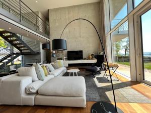 a living room with a white couch and a desk at Villa am See mit privatem Seezugang in Meersburg