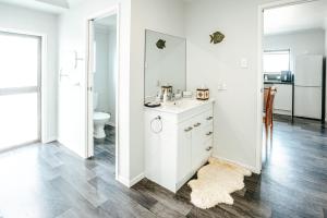 a white bathroom with a sink and a toilet at Sunrise Accommodation in Whakatane