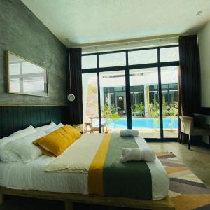 a bedroom with a bed with a view of a pool at Pacifico El Paredon in El Paredón Buena Vista +43 photos