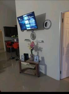 a living room with a tv on the wall at Royal Palm Luxury Villas in Ocho Rios