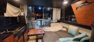 a living room with a couch and a table at BATEAU à Quai in Avignon