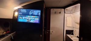 a small room with a tv on the wall at BATEAU à Quai in Avignon +12 photos
