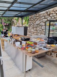 a buffet line with food on top of it at Premium OAZA in Primošten