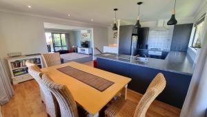 a kitchen and dining room with a table and chairs at 5b Torquay Tce in Hanmer Springs