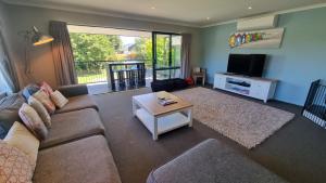 a living room with a couch and a table at 5b Torquay Tce in Hanmer Springs