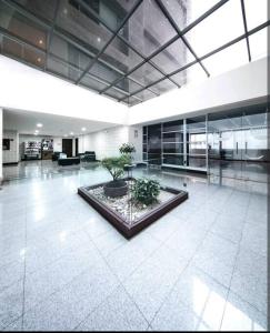 a large building with a lobby with a plant at Suite bussines half of the world 12 in Quito