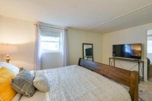 Schlafzimmer mit einem Bett und einem Flachbild-TV in der Unterkunft District Heights Apartment with Patio and Seating in District Heights