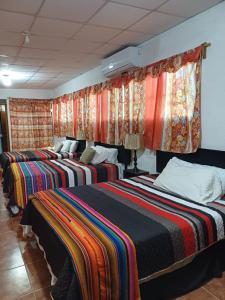 a row of beds in a room with curtains at Santa Gertrudis in El Rancho