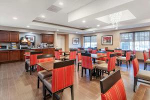 a restaurant with red chairs and tables in a room at Comfort Inn & Suites Dover-Portsmouth in Dover