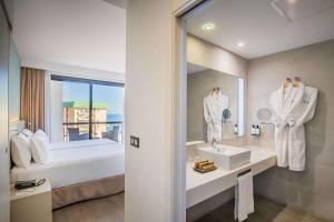 een badkamer met een wastafel en een spiegel bij Occidental Fuengirola in Fuengirola